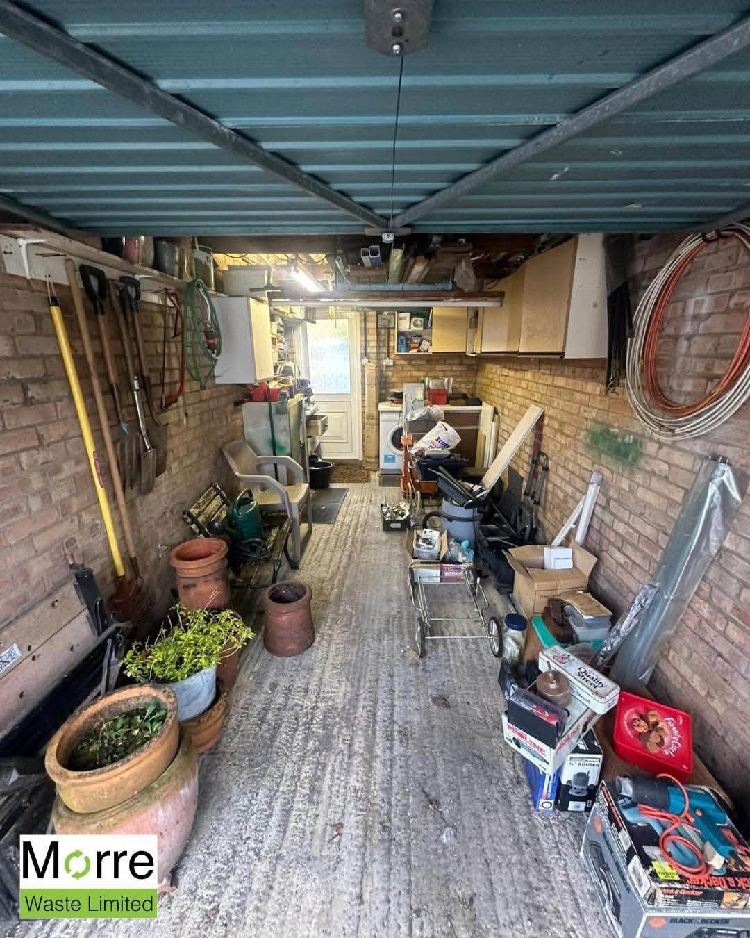 Lean-to garage before clearance, full of stored items